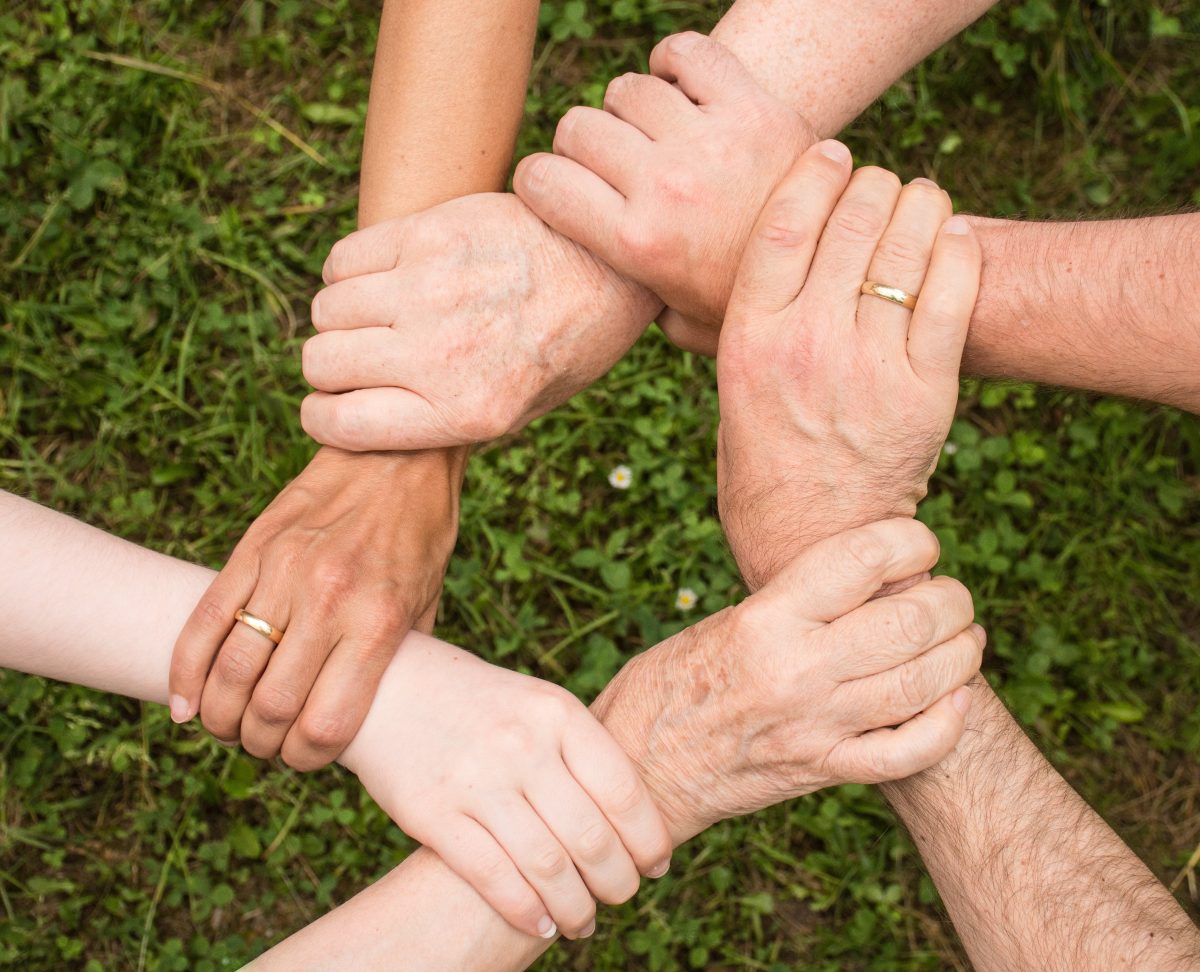 hands collaborating to form a hexagon