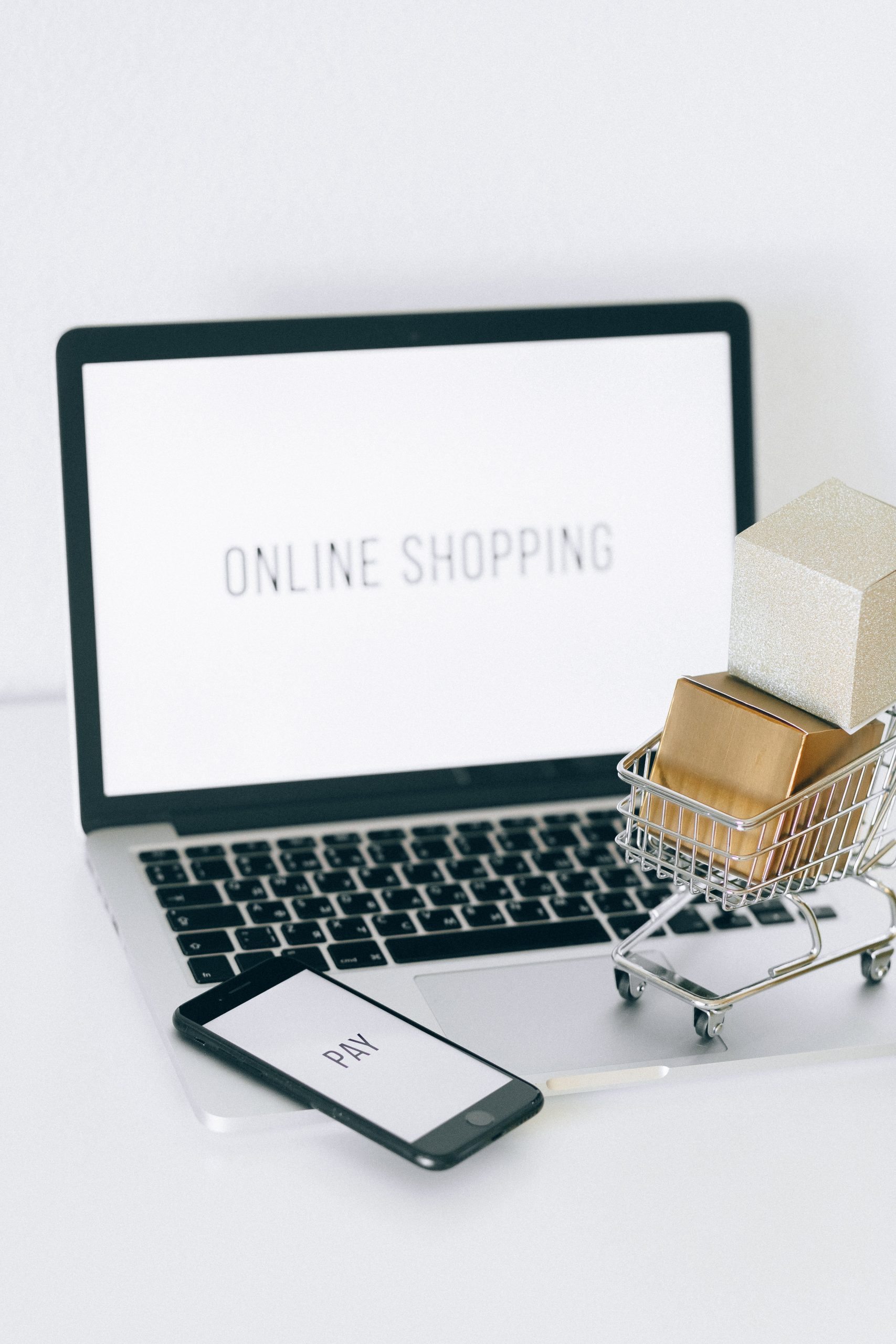Picture of a computer and a miniature shopping cart