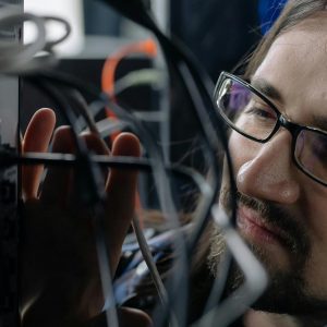 a person connecting network cable on a router