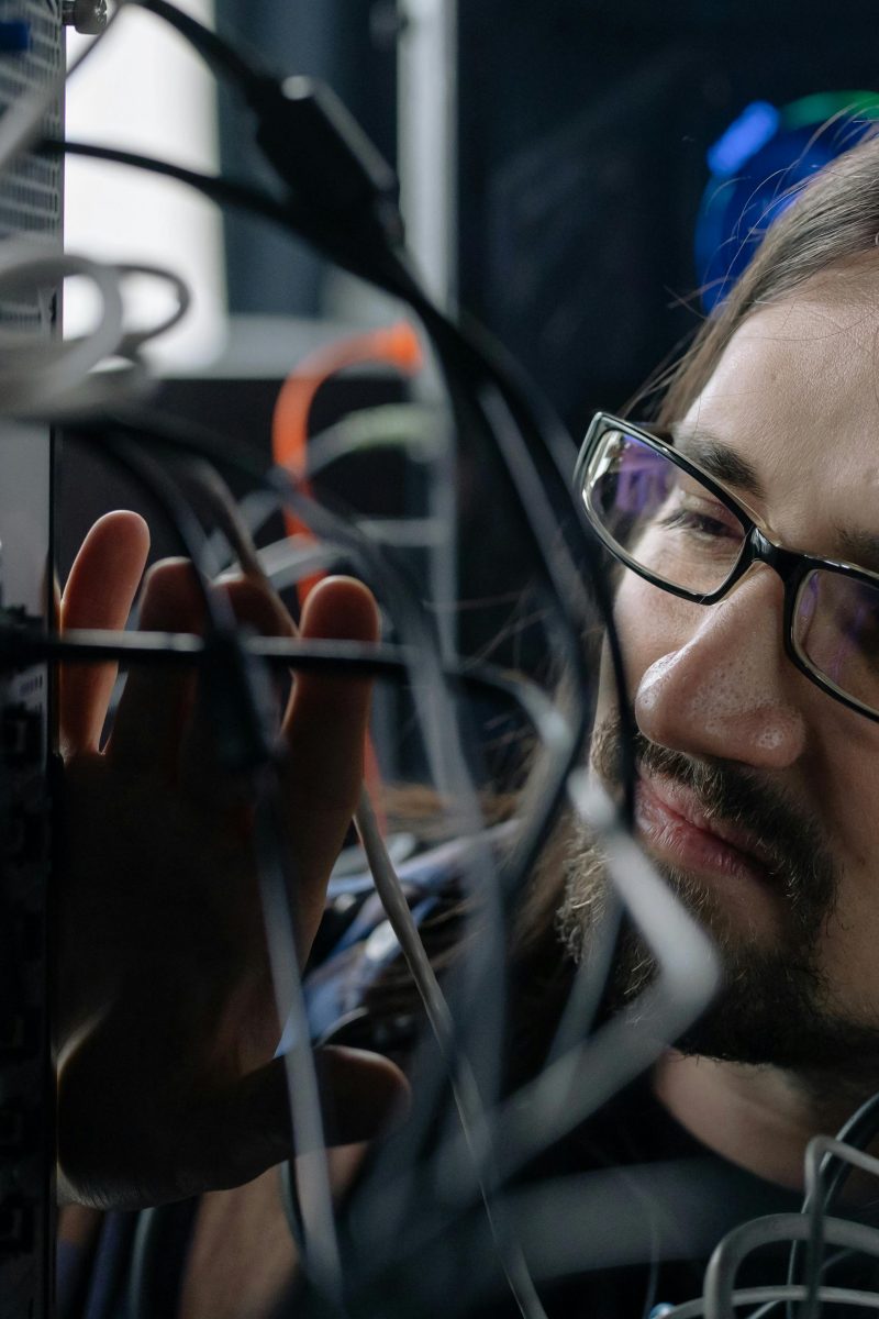 a person connecting network cable on a router